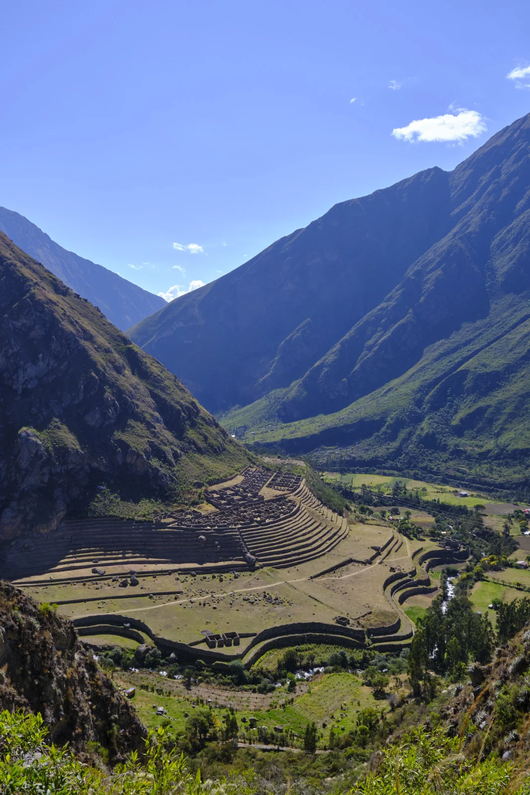 Llactapata (Patallacta) on a terrace-cut spur above the Urubamba: curved agricultural terraces and stone building foundations between the canyon walls
