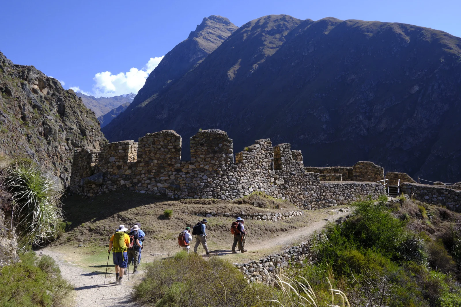 Upper walls at Llactapata, rectangular niches and doorways in fieldstone masonry against a steep ridge