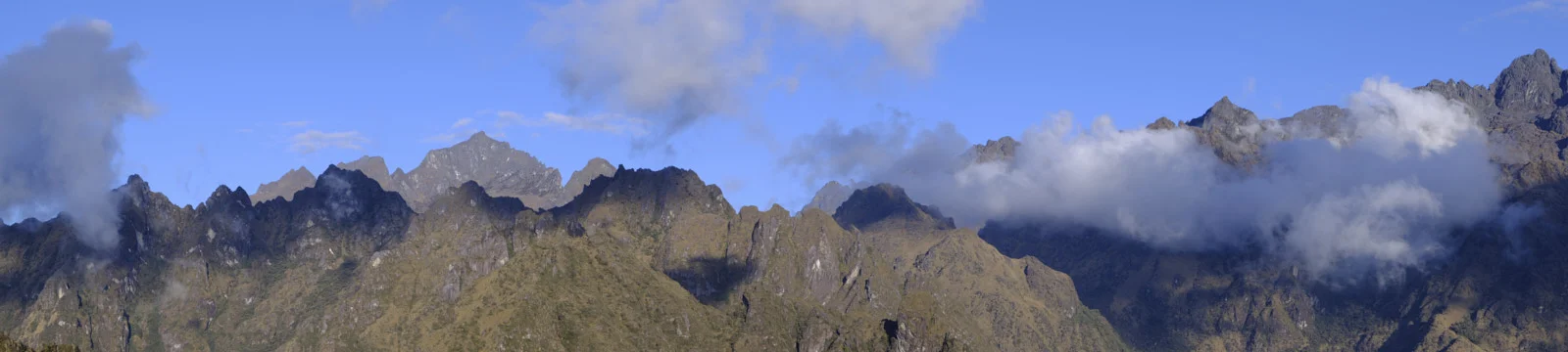 Cloud-wreathed ridgelines from Phuyupatamarca, grassy slopes and rocky summits