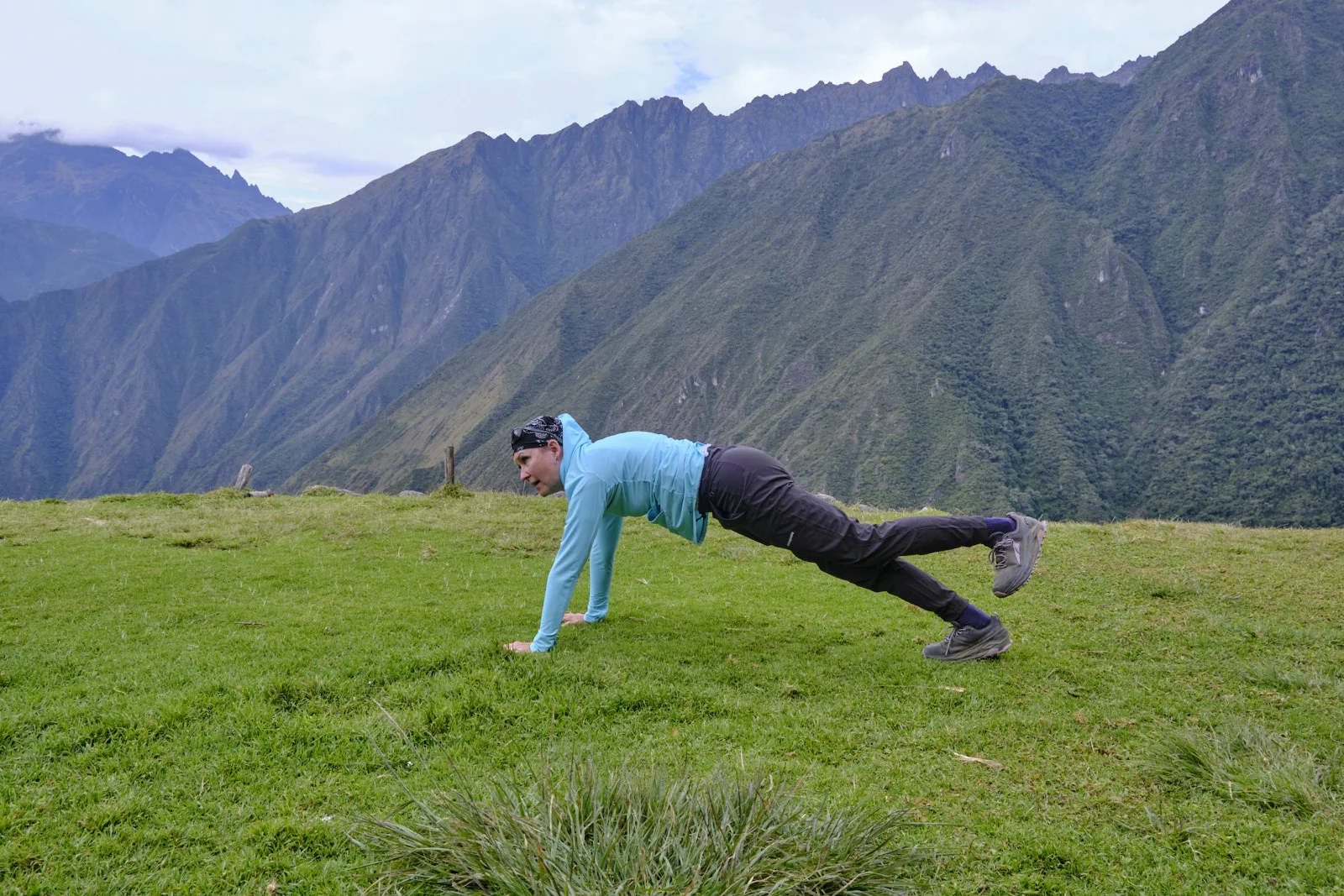 Grassy terrace at Intipata overlooking forested canyon walls of the Urubamba valley