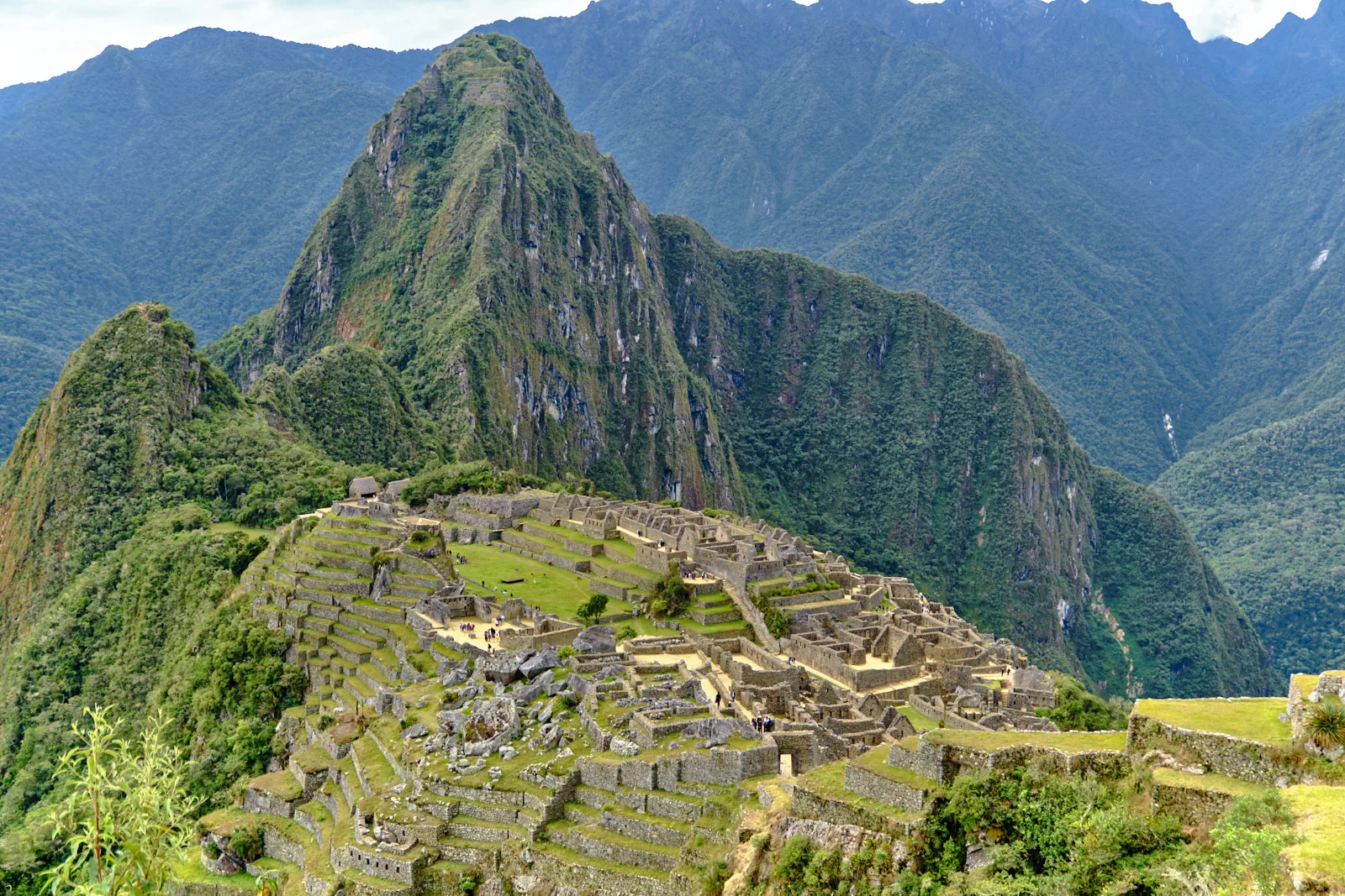Machu Picchu citadel and agricultural terraces, Huayna Picchu rising behind the site and Putucusi at left