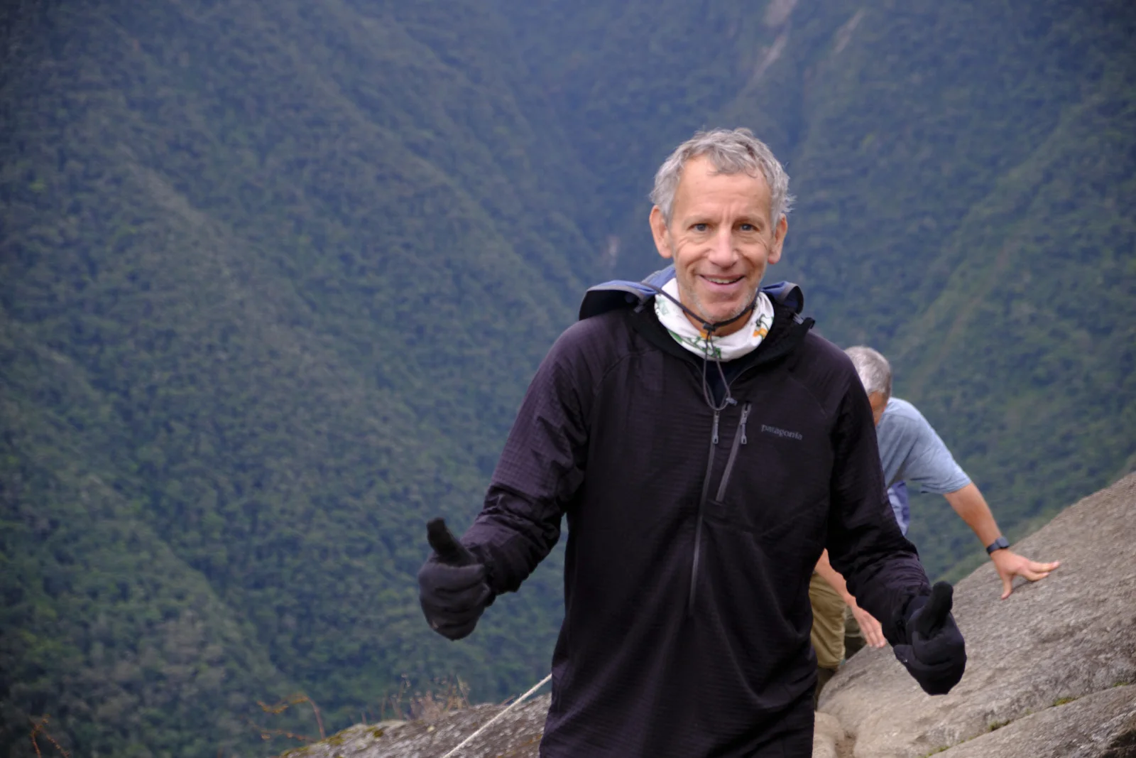 Steep granite trail on Huayna Picchu, a cable along the rock and the forested Urubamba canyon below