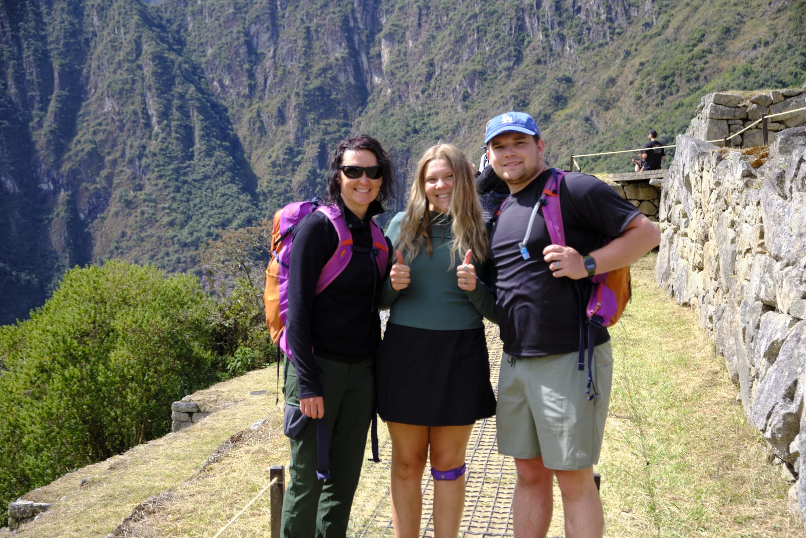 Terrace path at Machu Picchu beside a stone retaining wall, the Urubamba canyon dropping away at left