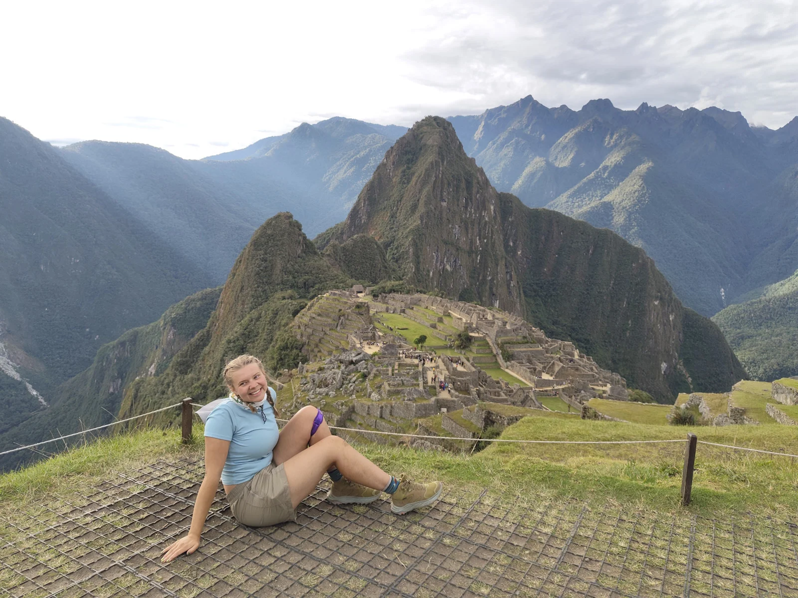 Classic Machu Picchu viewpoint on the upper terraces, Huayna Picchu behind the citadel and Putucusi to the left