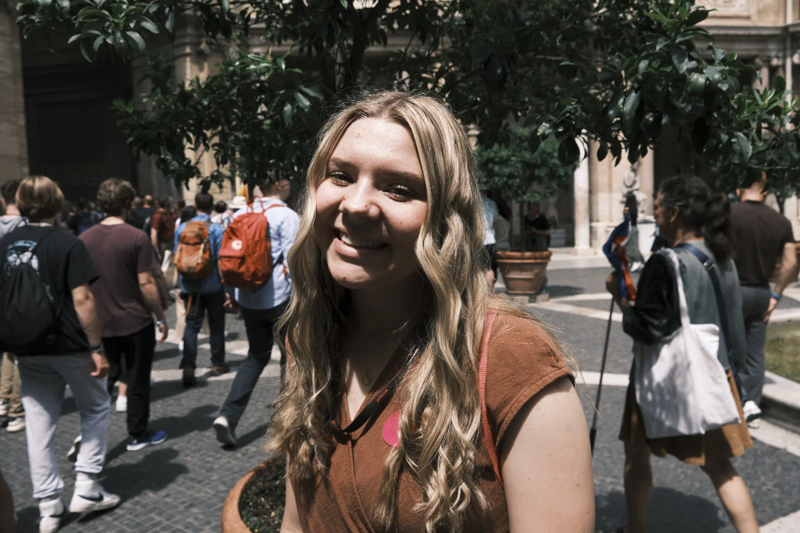 Portrait in a Vatican Museums courtyard with orange trees and a colonnade