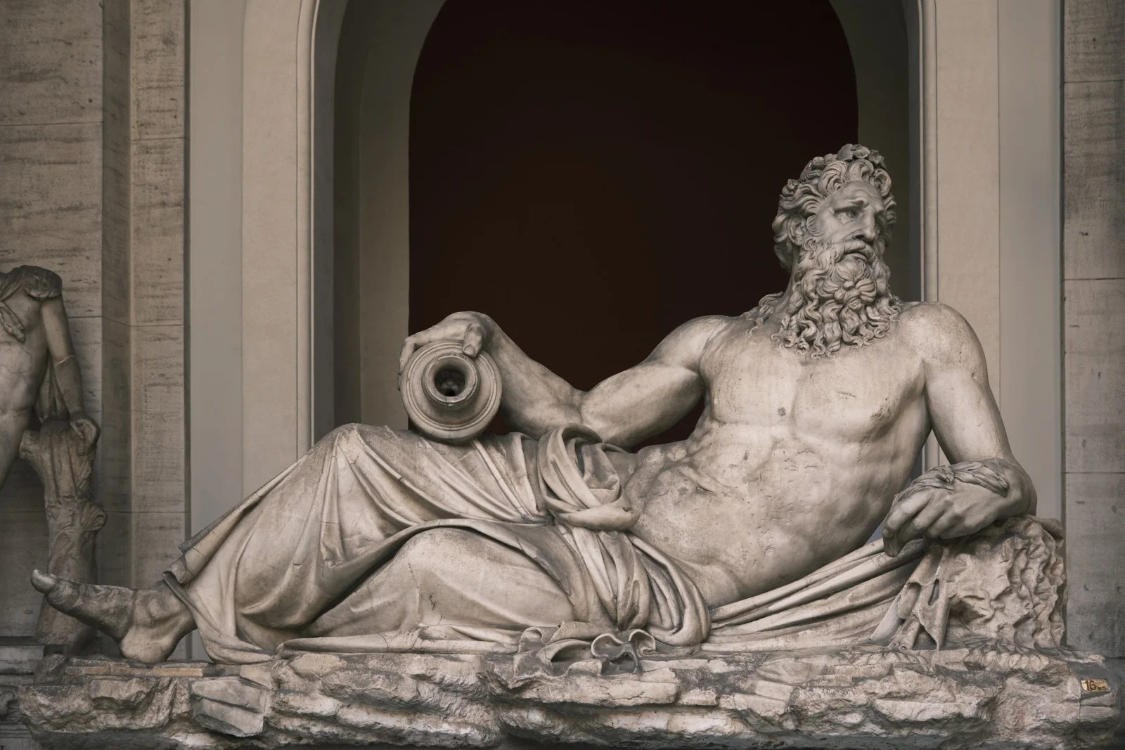Marble statue of a reclining bearded river god holding an urn