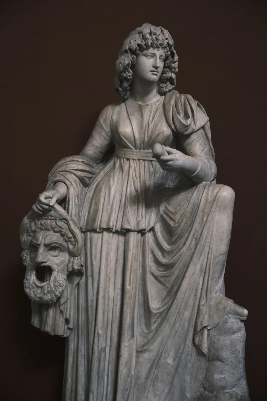 Marble statue of Melpomene holding a theatrical mask