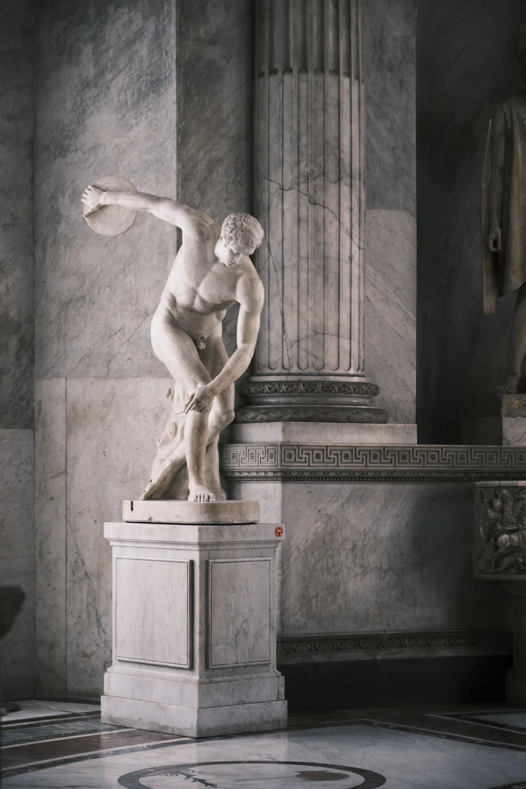 Marble Discobolus statue in a marble hall of the Vatican Museums