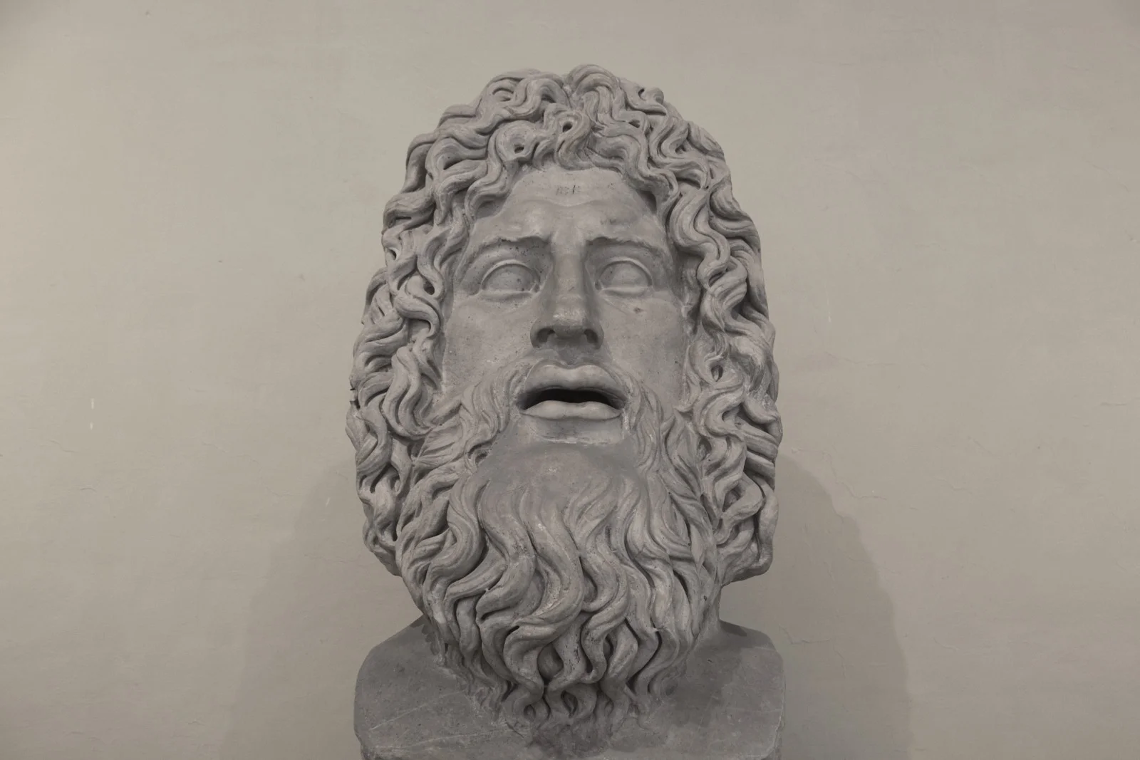 Colossal marble head of bearded Zeus with open mouth