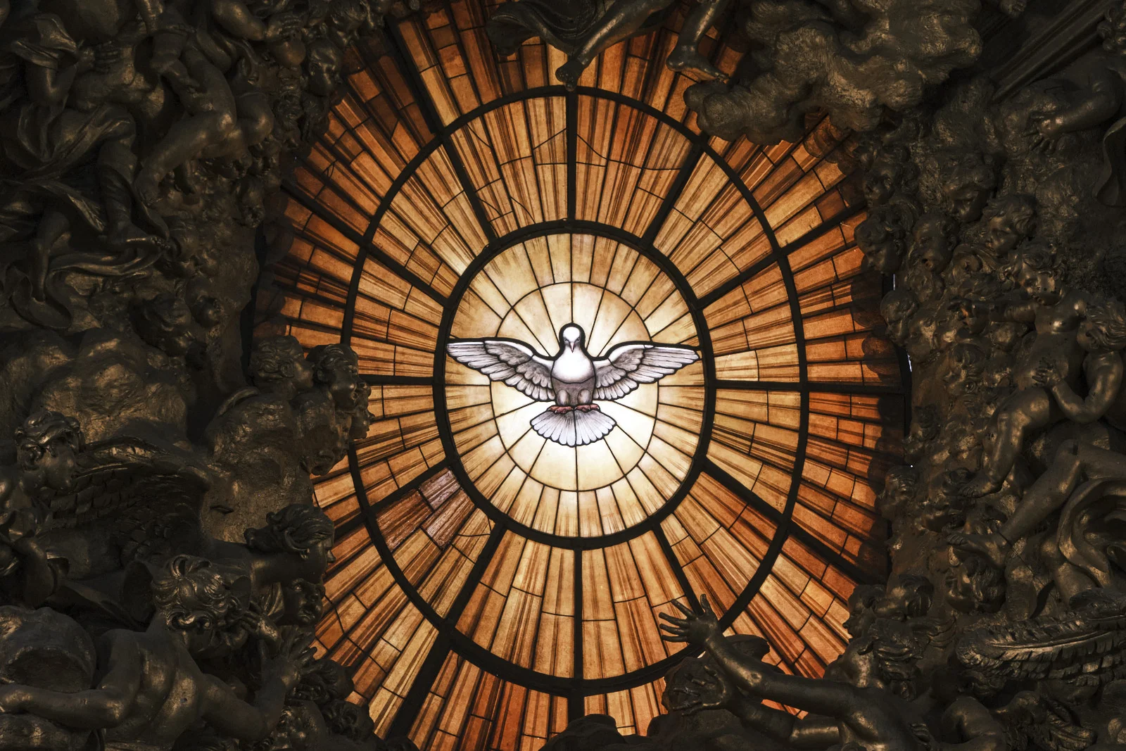 Stained-glass dove of the Holy Spirit in a gilded sunburst, St. Peter’s