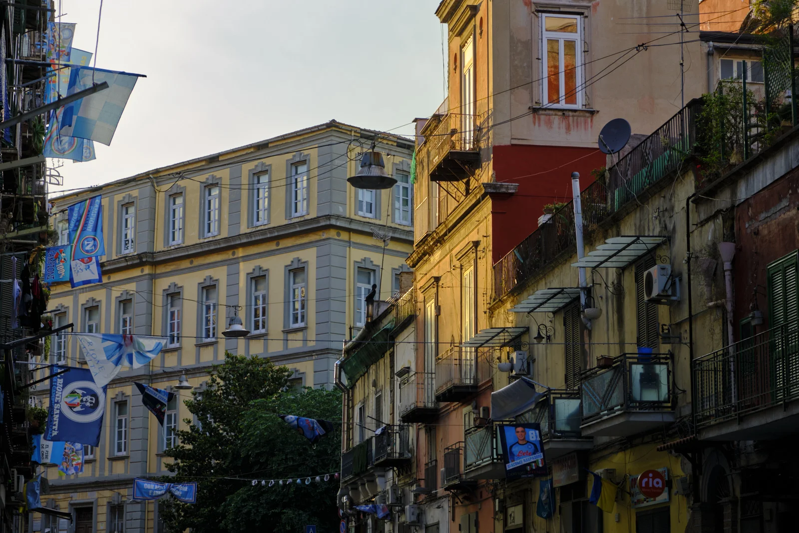Neapolitan street with football flags and laundry on balconies