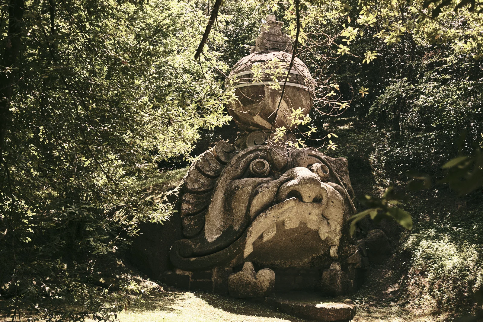 Giant stone ogre’s mouth in a wood, Park of the Monsters, Bomarzo