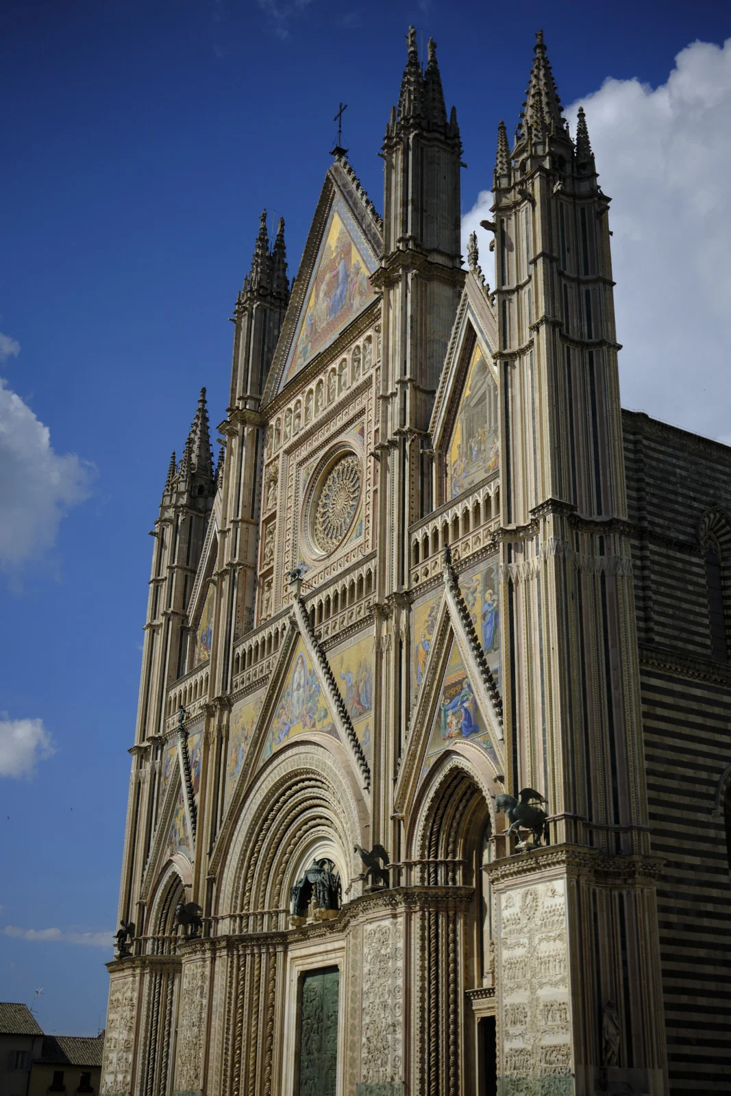 Facade of Orvieto Cathedral with mosaics and Gothic gables