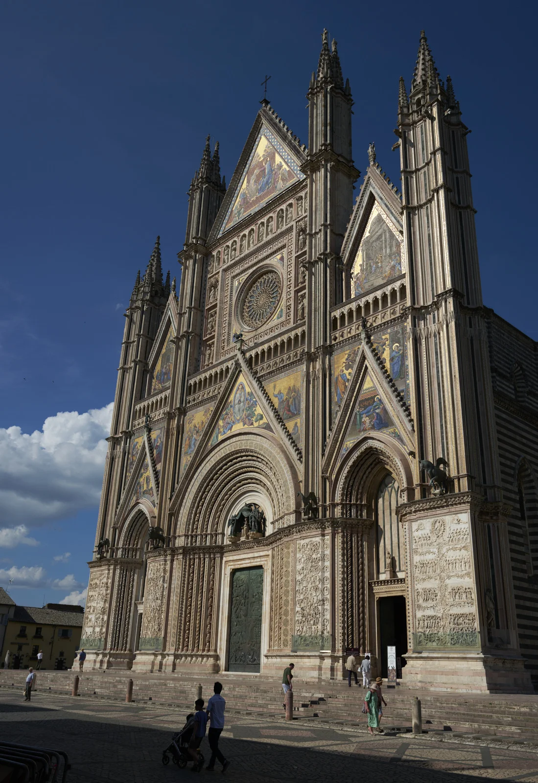 Wide view of Orvieto Cathedral facade from the square