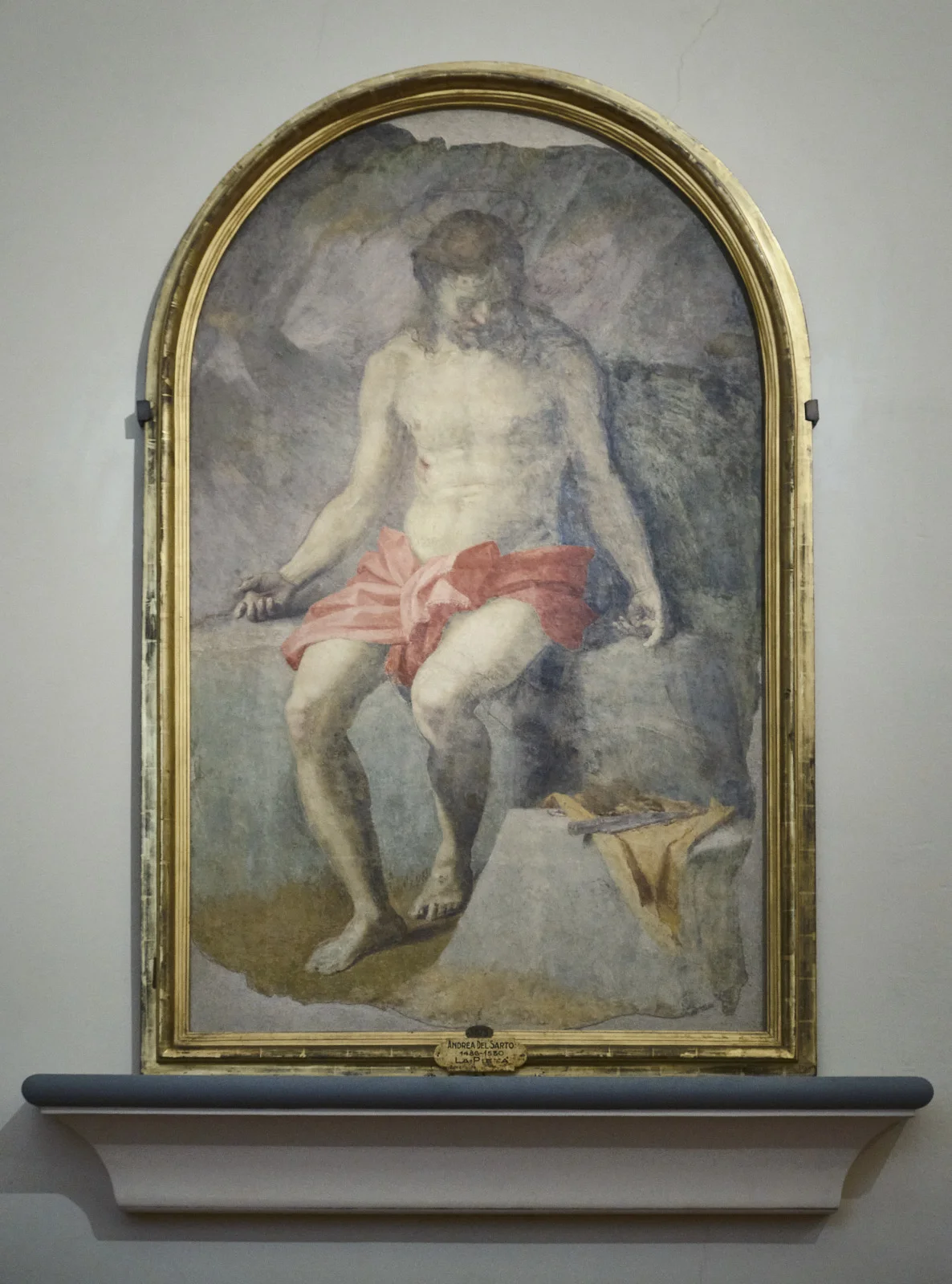 Painting of a seated Christ with a red cloth, labeled Andrea del Sarto