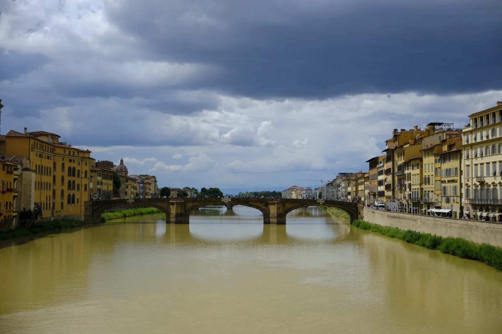 The Arno in Florence with Ponte Santa Trinita under a dark sky