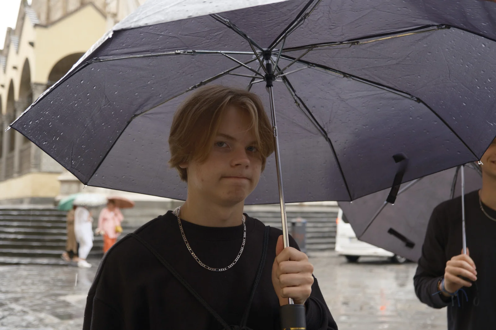 Person with an umbrella in a rainy piazza in Florence