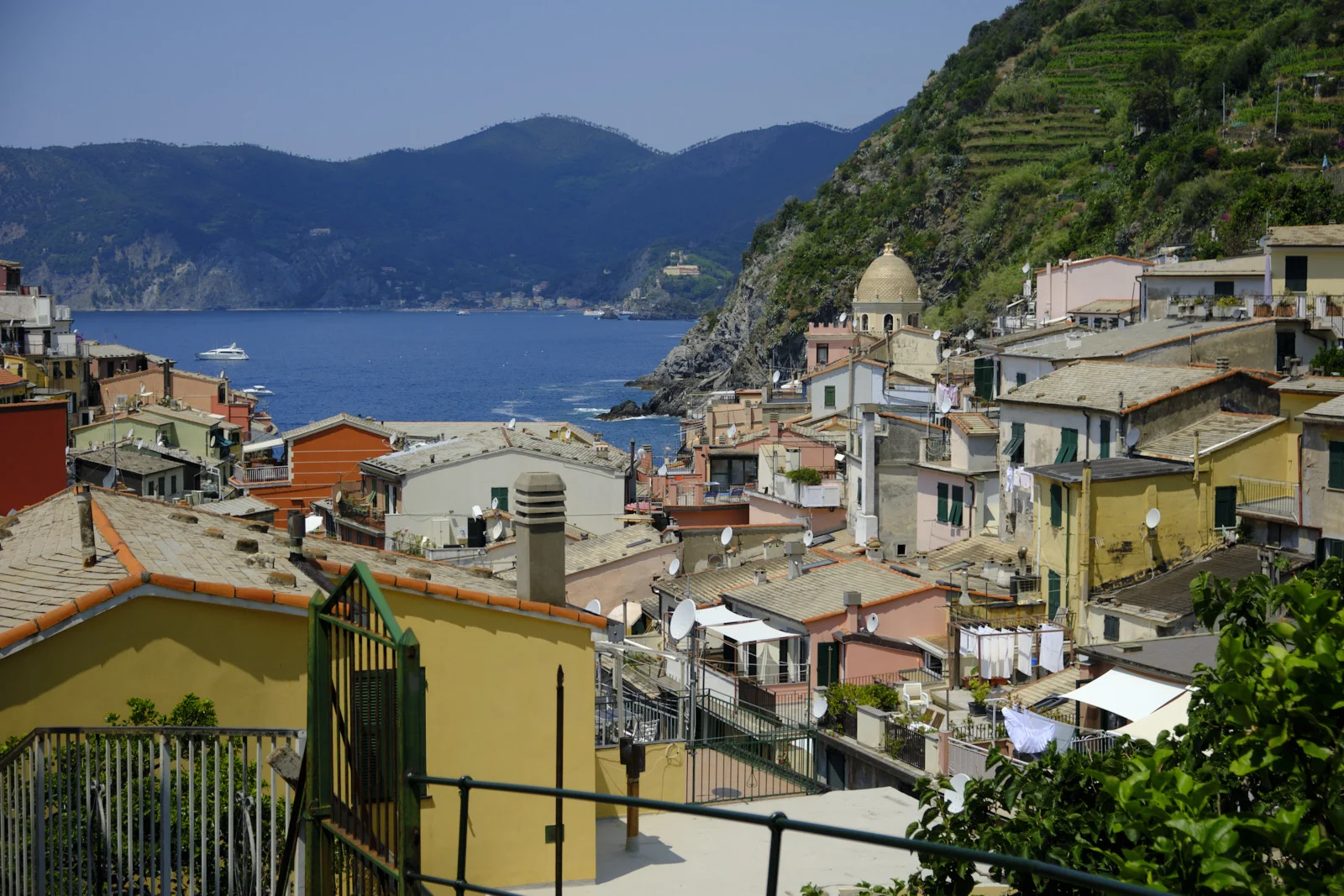 Vernazza rooftops and harbor looking toward green mountains