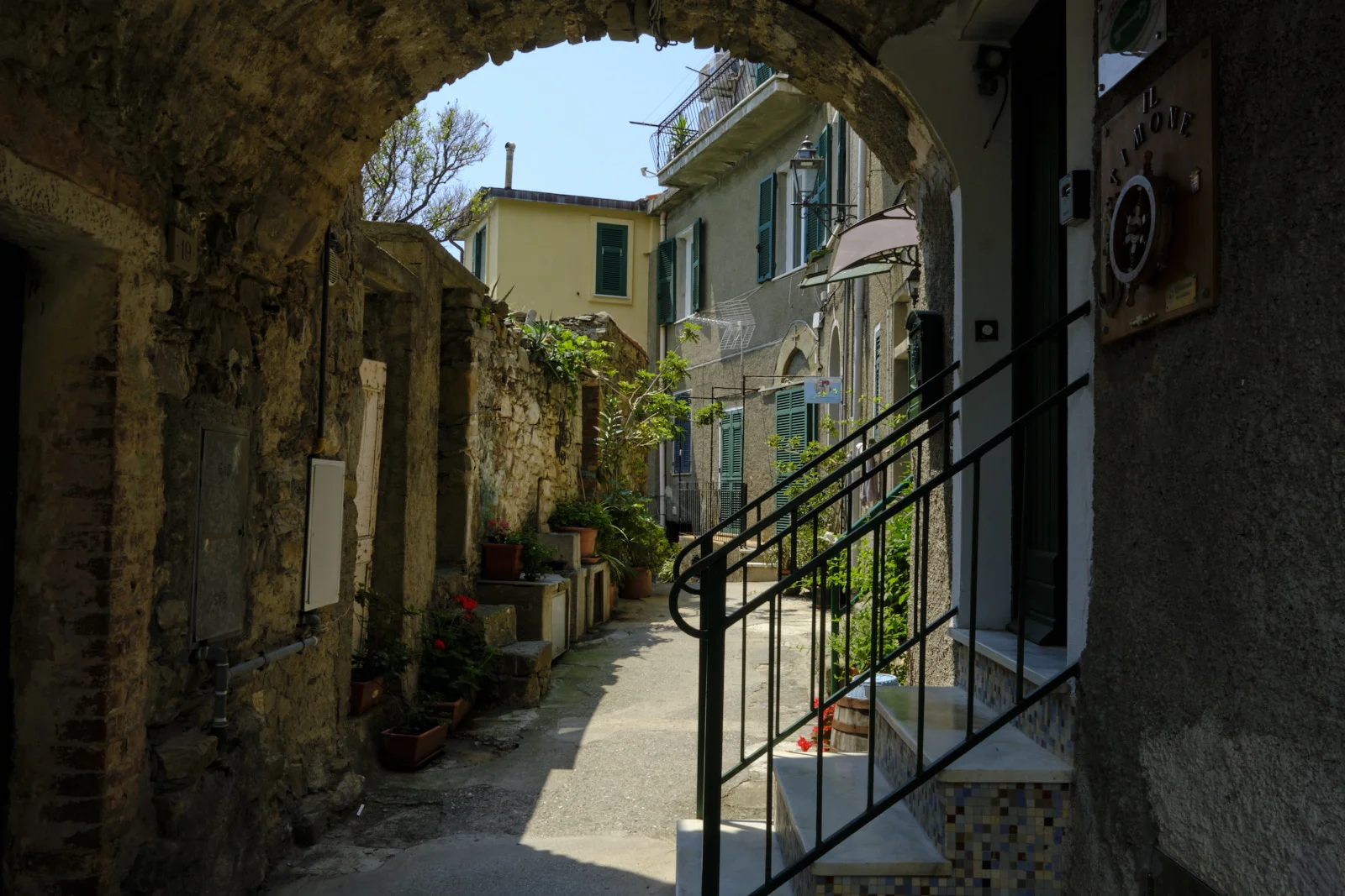 Stone alley with an arch and outdoor stairs in a Cinque Terre village