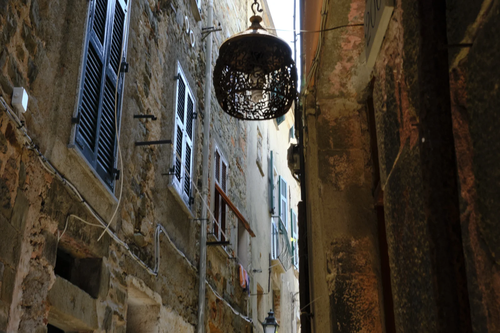 Narrow stone street with a metal lantern