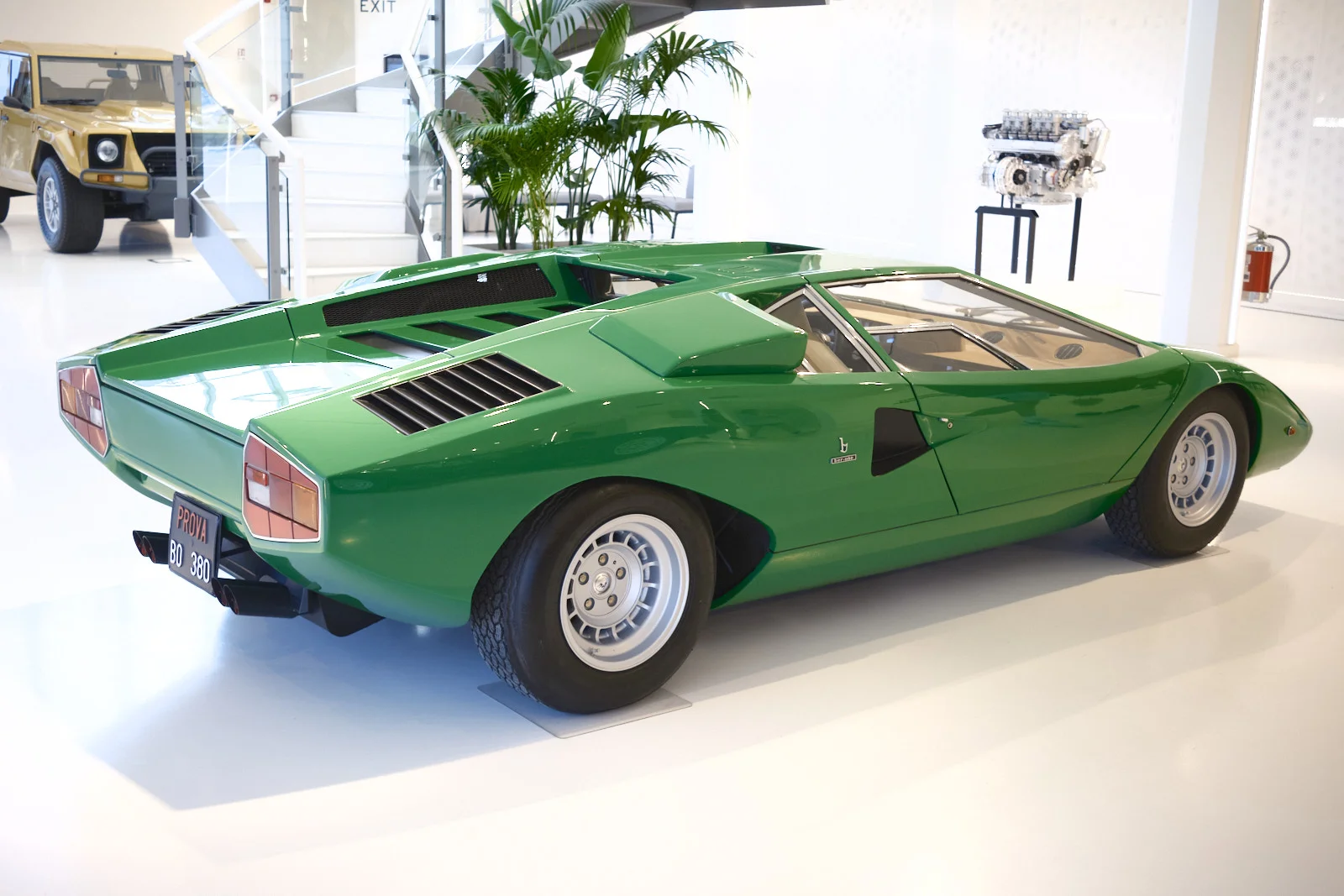 Green Lamborghini Countach in a white museum hall