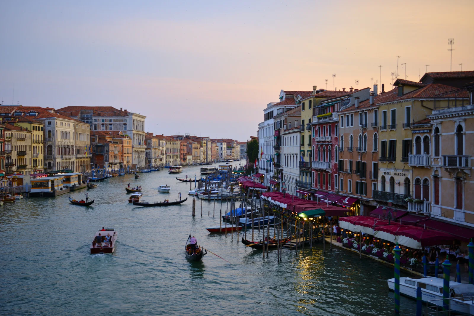 Grand Canal at sunset with gondolas and restaurant awnings