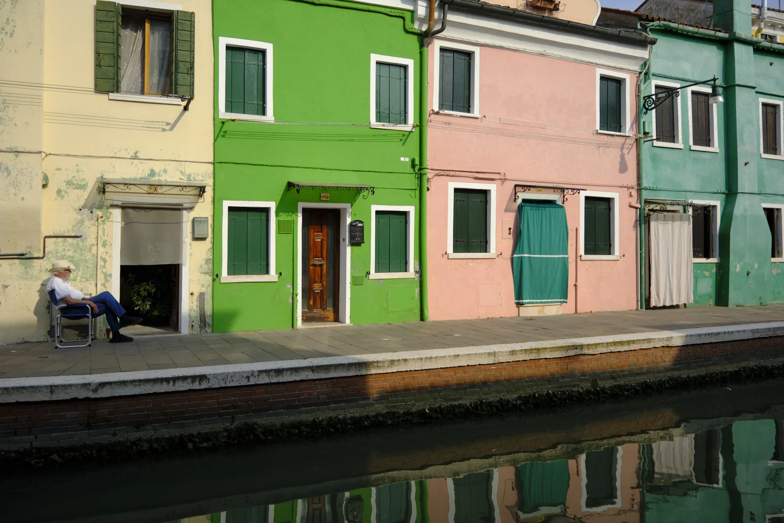 Colorful Burano houses reflected in a canal