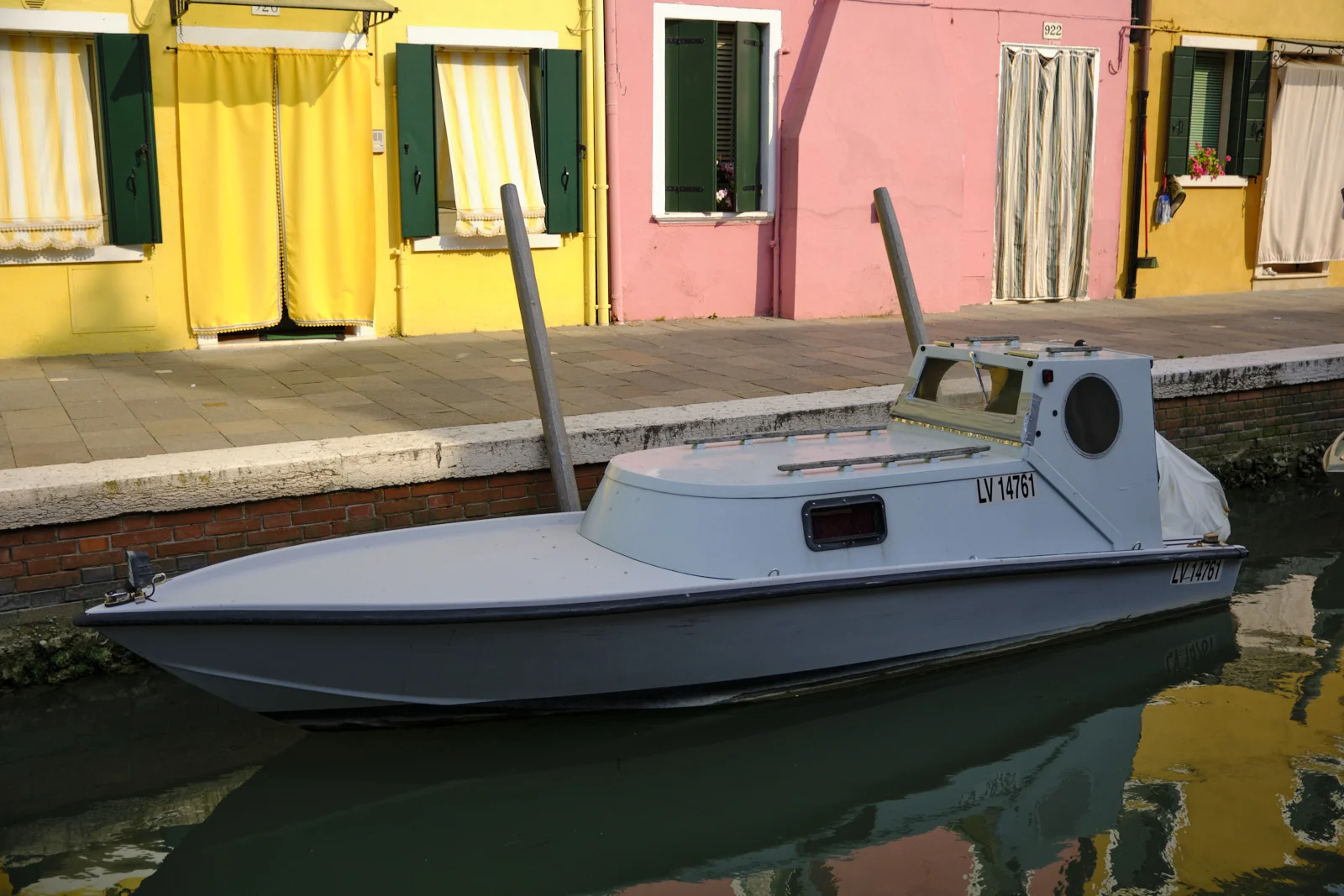 Small grey motorboat on a canal in Burano