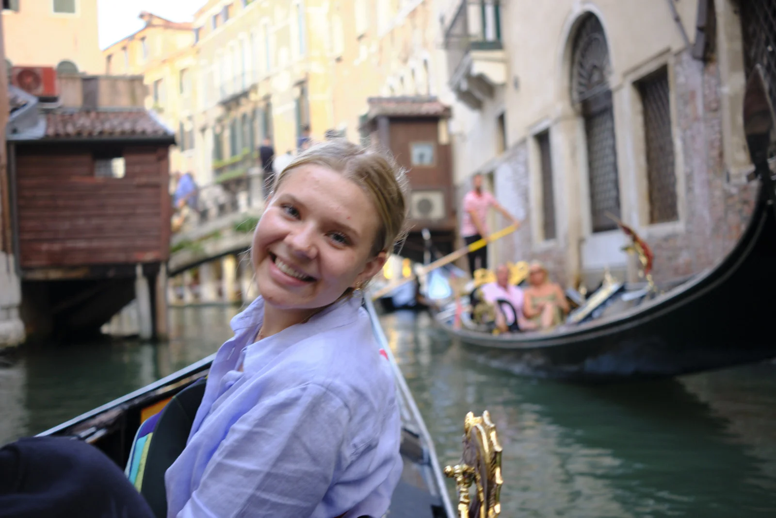 Portrait in a gondola on a narrow Venice canal