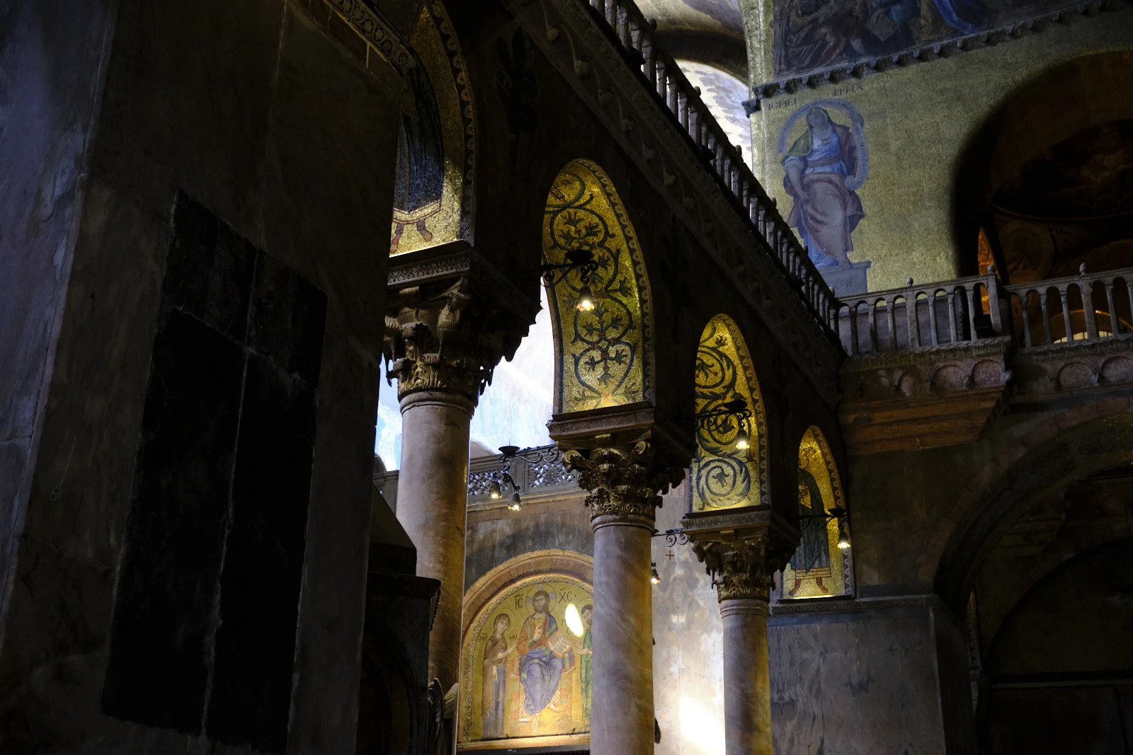 Gallery arches and a mosaic of Christ in St. Mark’s Basilica