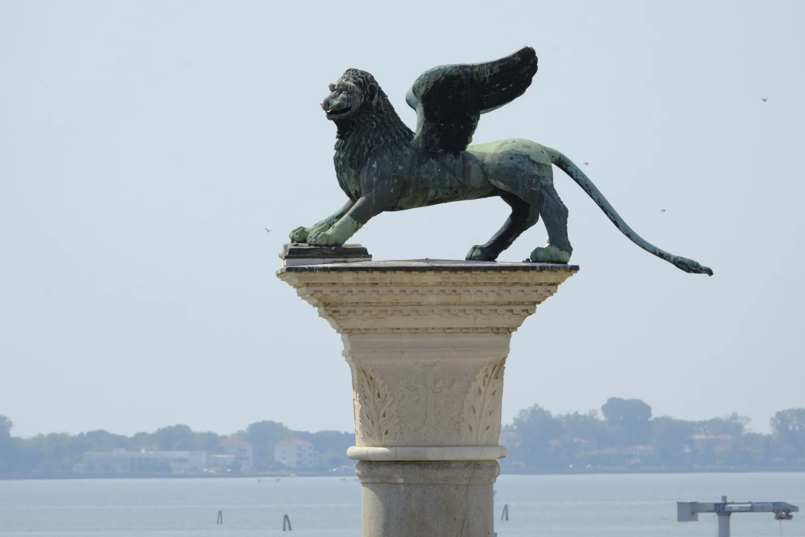 Bronze winged lion of St. Mark on its granite column in the Piazzetta