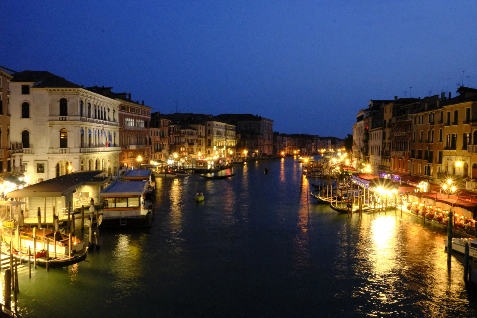 Grand Canal at night from the Rialto Bridge, vaporetto stop and gondolas