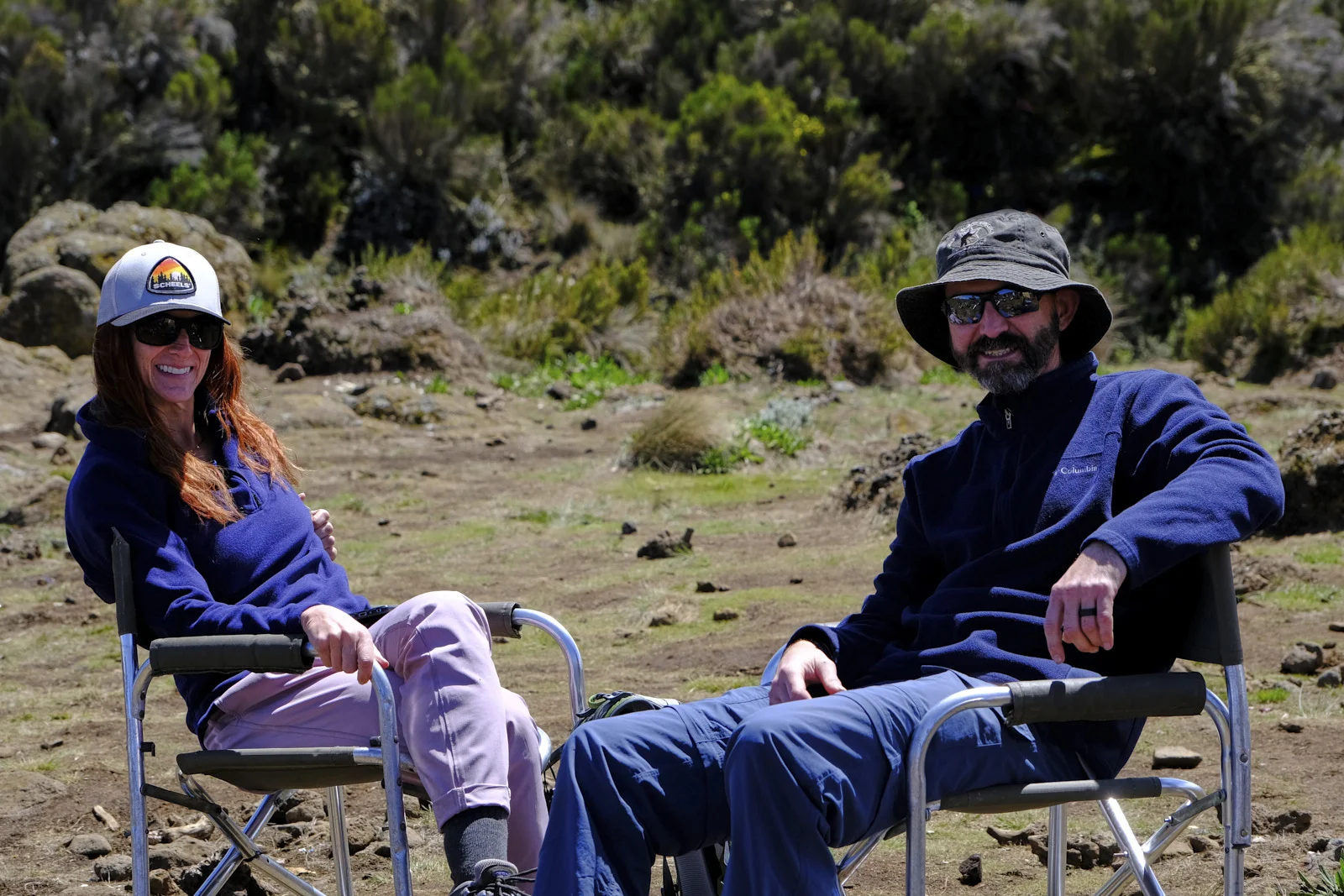 Two climbers sitting in camp chairs on the moorland