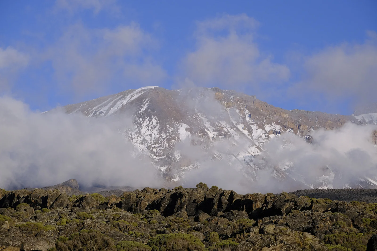 Snow on Kibo’s cliffs above lava rock on the Shira plateau