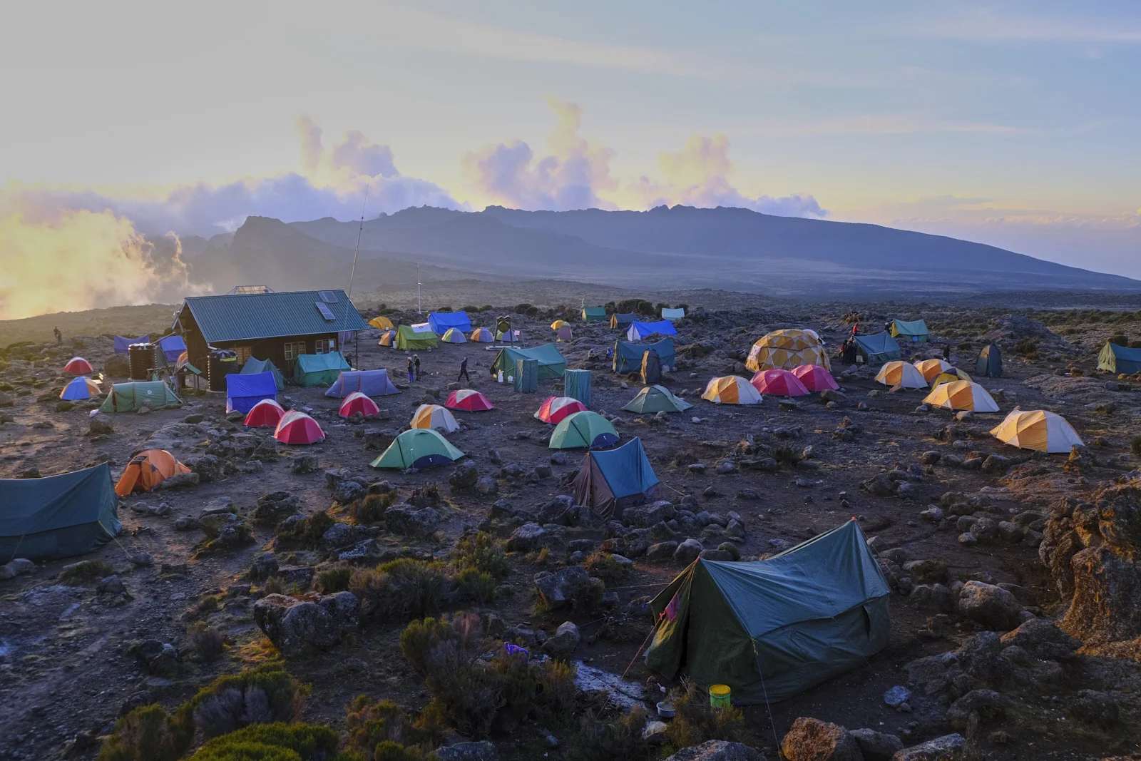 Colorful tents and a green-roofed hut on the Shira plateau