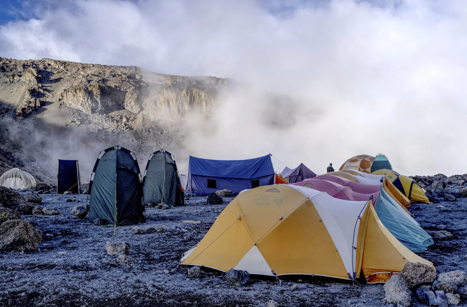 Tents at Barafu Camp in mist below a rocky slope