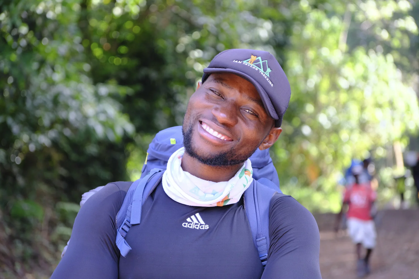 Guide in an Adidas shirt and Ian Taylor Trekking cap