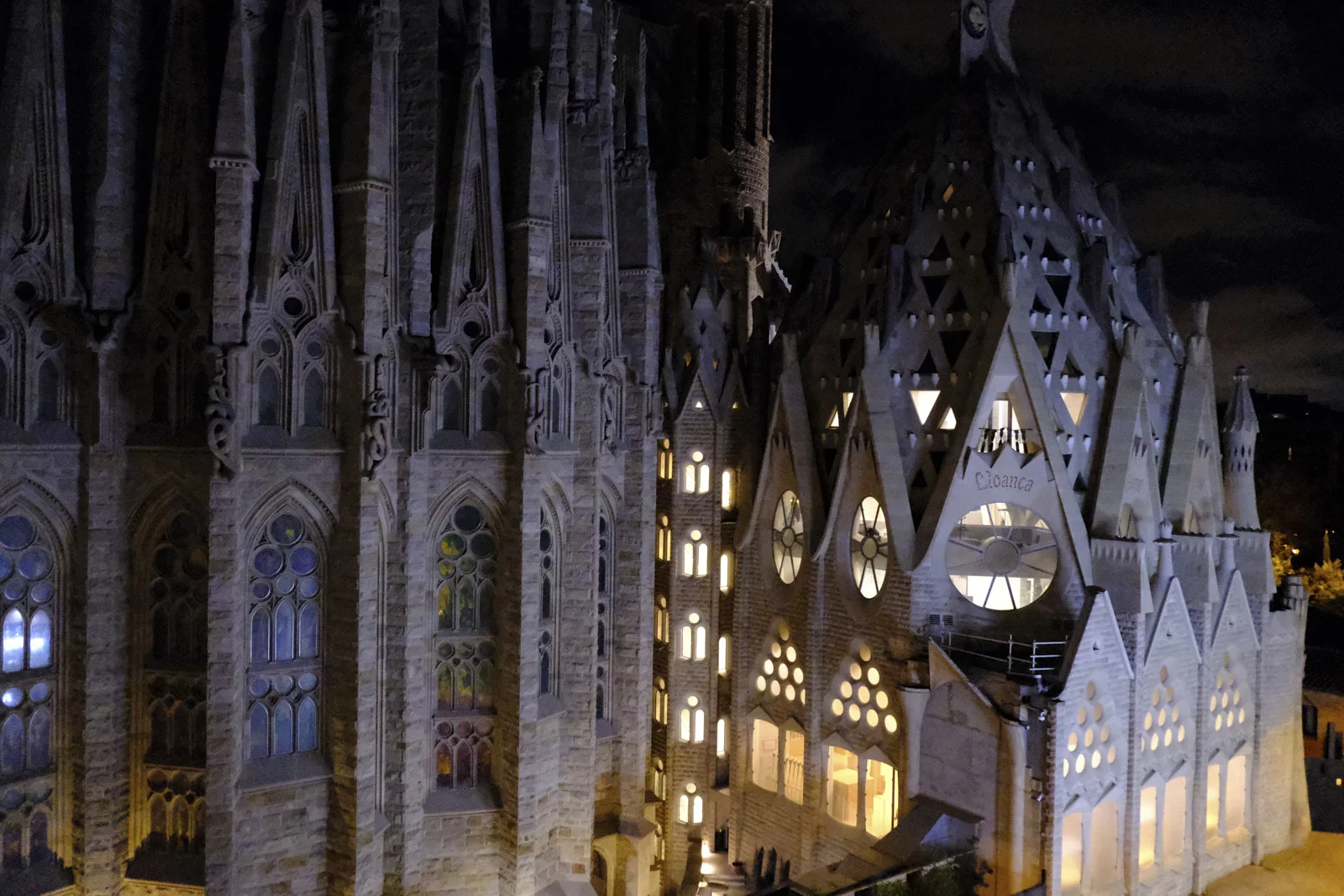 The Nativity facade towers and the adjoining sacristy of the Sagrada Família in Barcelona, with the word Lloança on a pediment.