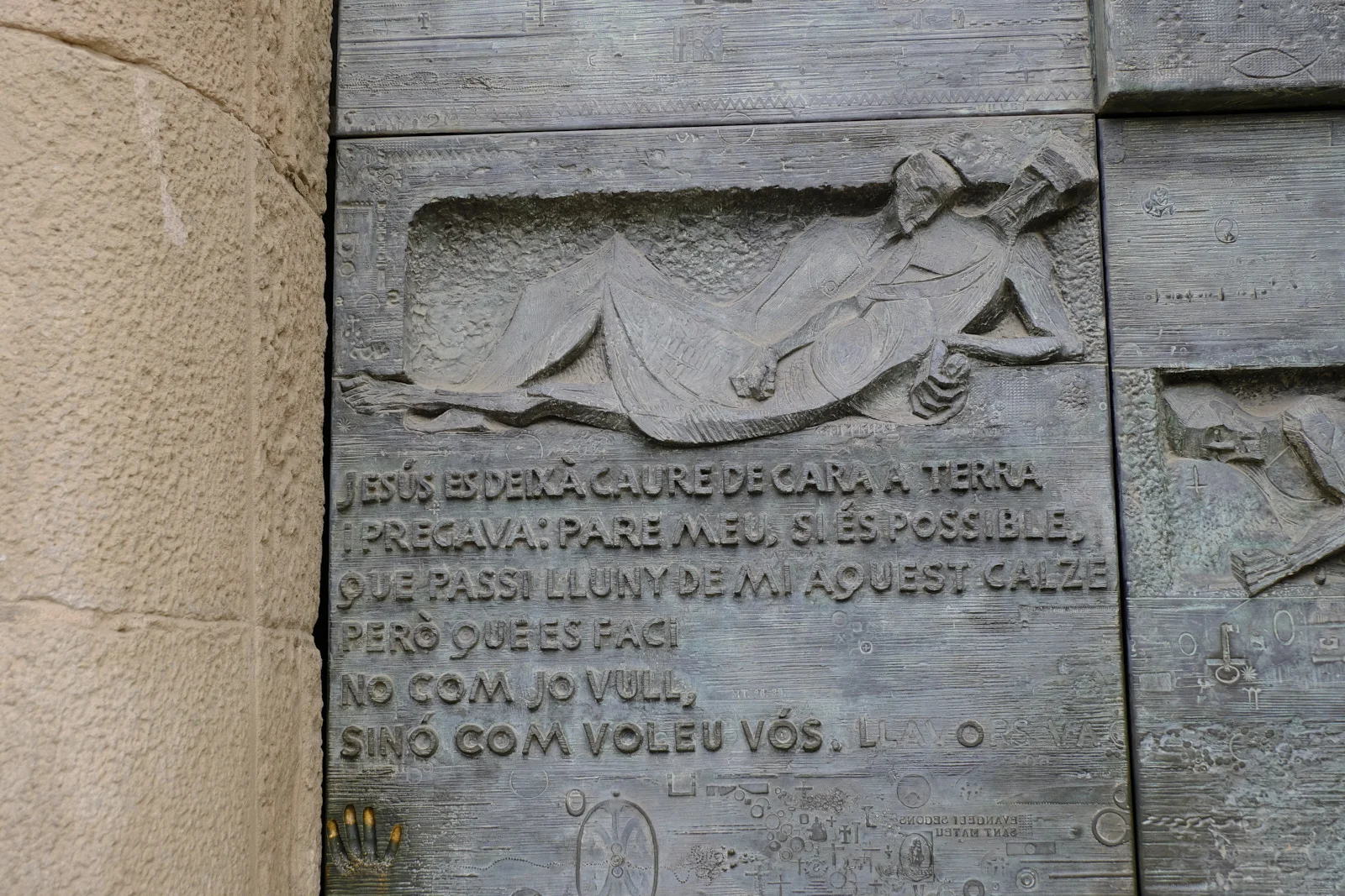 Bronze relief of Jesus prostrate in Gethsemane on the Passion facade door of the Sagrada Família in Barcelona.