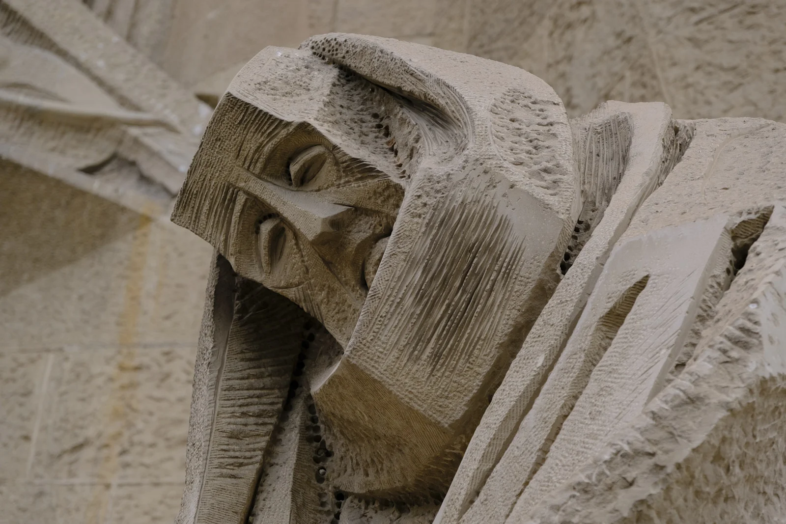 A hooded stone figure on the Passion facade of the Sagrada Família in Barcelona.