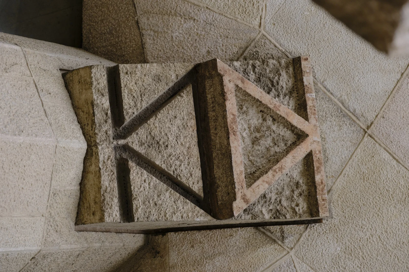 A geometric stone carving on the Passion facade of the Sagrada Família in Barcelona.