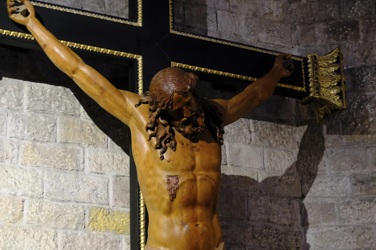 A wooden crucifix on a cross inside Santa Maria del Mar in Barcelona.