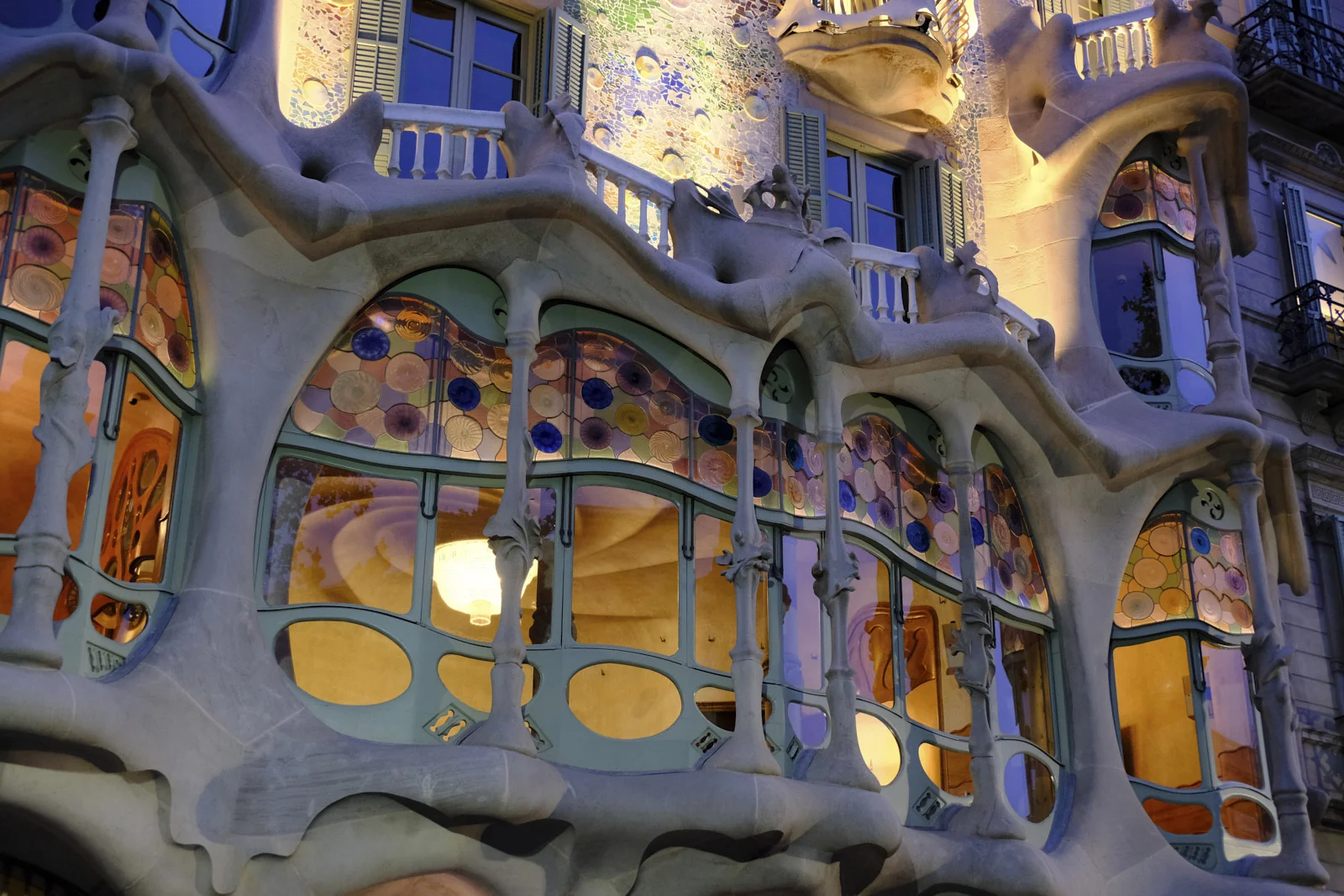 The stone gallery and windows of Casa Batlló on Passeig de Gràcia in Barcelona.
