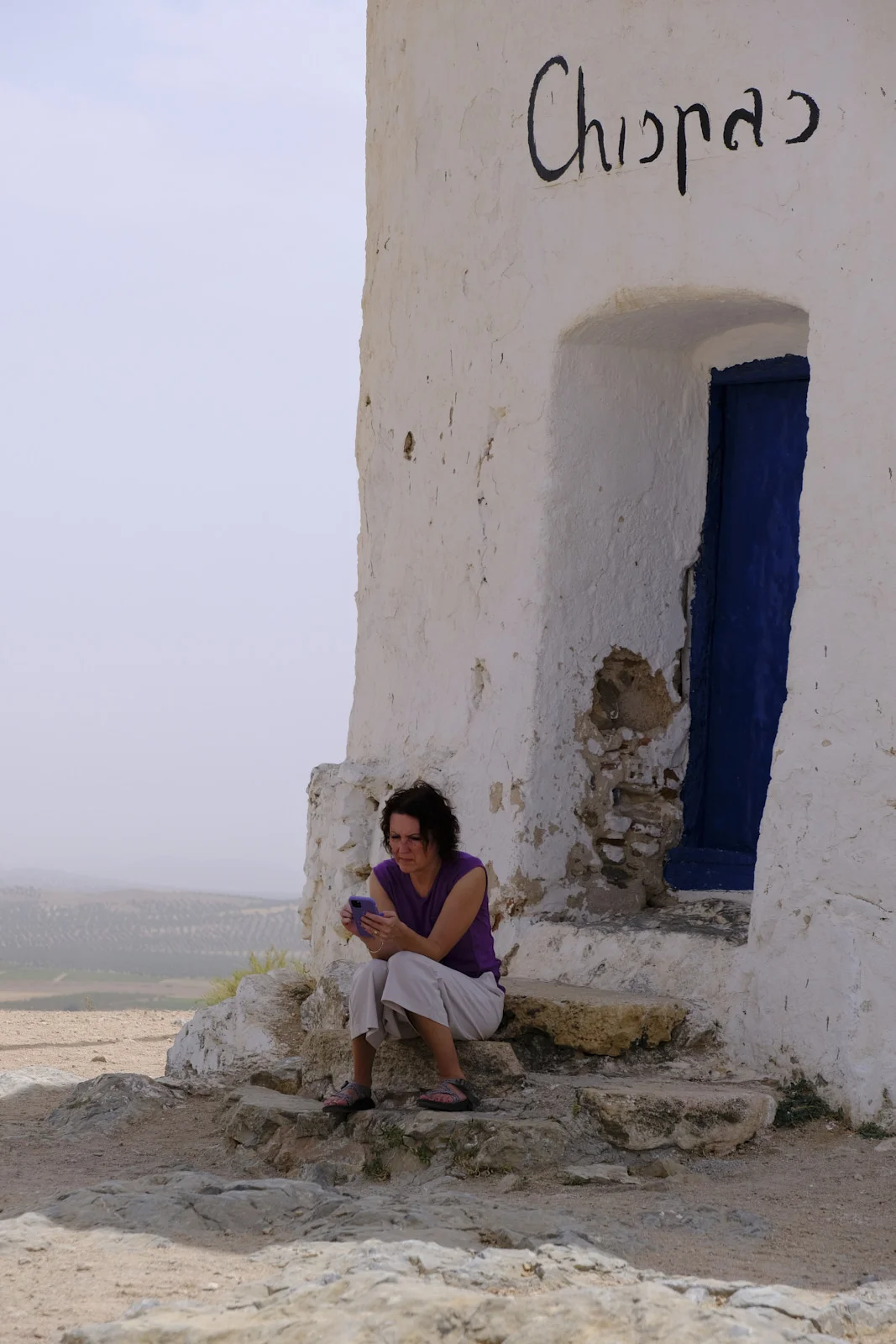The doorway of the windmill Chispas at Consuegra, with the name painted above the door.