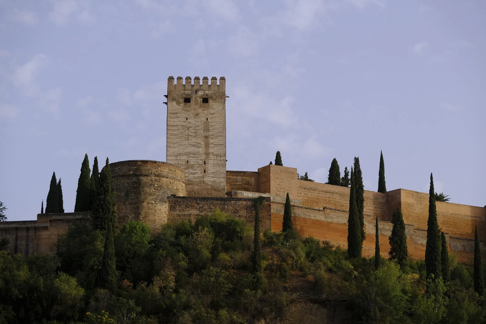 Torre del Homenaje and the walls of the Alcazaba in Granada, seen from below.