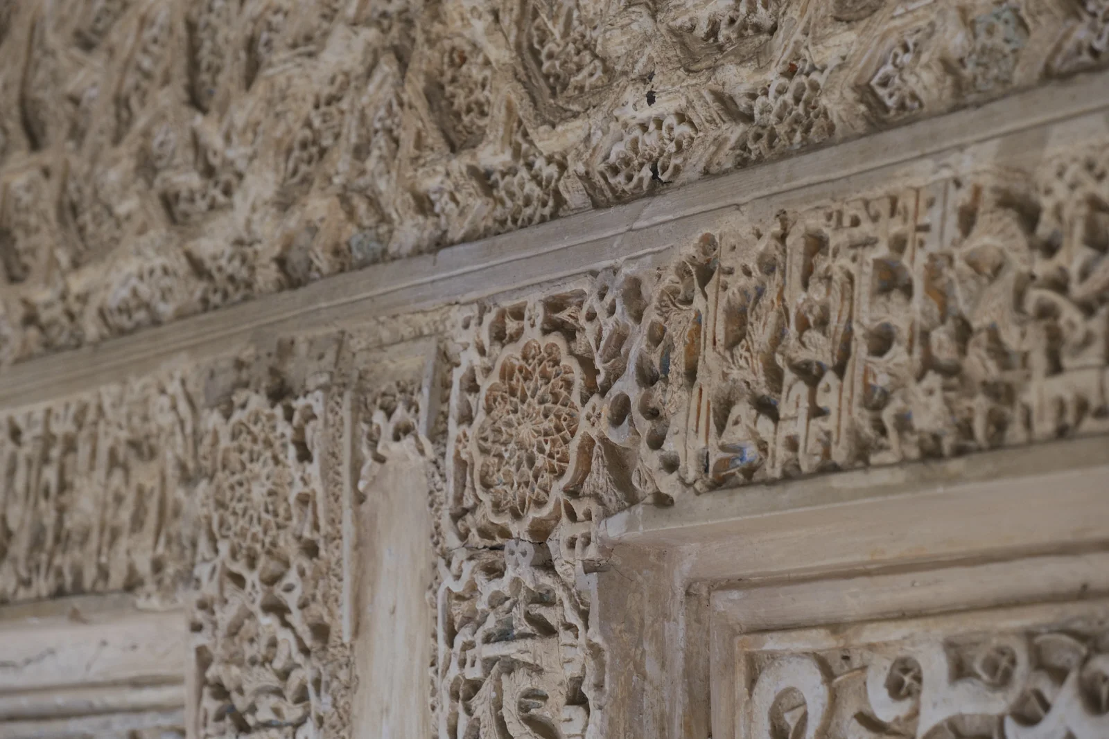 Carved plaster with geometric and vegetal ornament in the Nasrid palace of the Alhambra in Granada.
