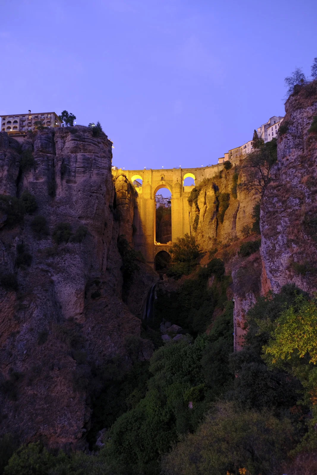 Cliffs rise on both sides of the gorge at Ronda, where Puente Nuevo crosses above a waterfall.