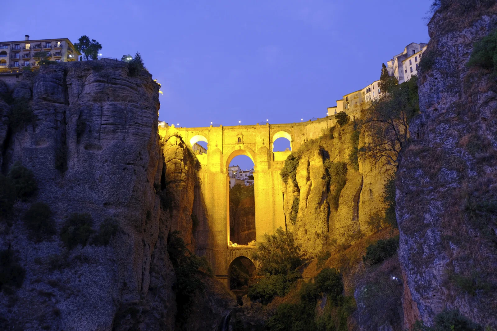Puente Nuevo runs between the cliffs of the gorge at Ronda, with houses on both sides.