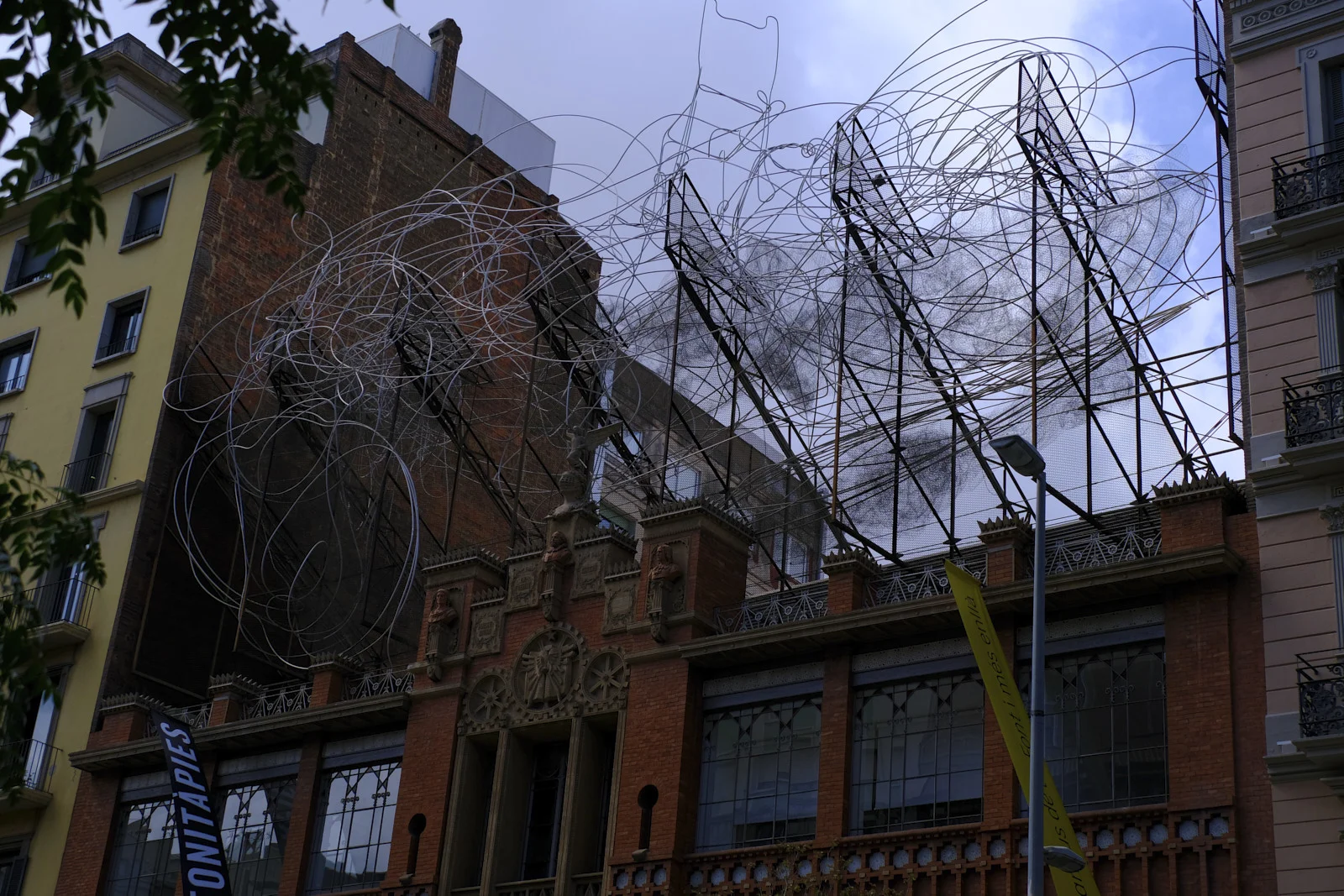 The wire sculpture Núvol i cadira sits on the roof of the Fundació Antoni Tàpies in Barcelona.