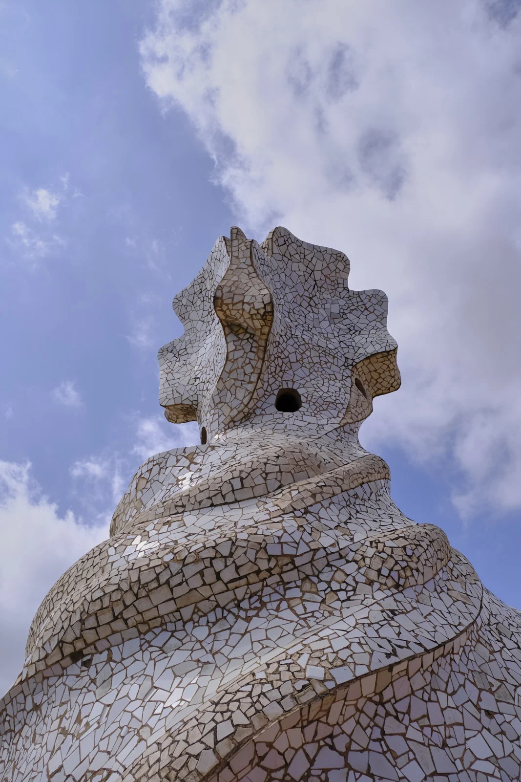 A stair tower covered in broken tile stands on the roof of La Pedrera in Barcelona.